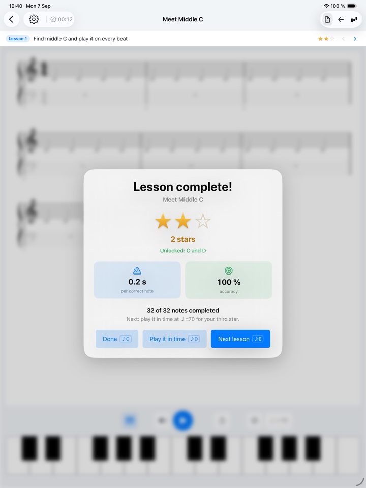 Lesson complete on iPad: two of three stars for Meet Middle C, with reaction time and accuracy